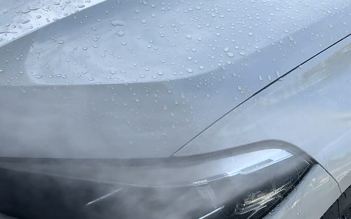 Water beading across the freshly waxed hood of a white SUV
